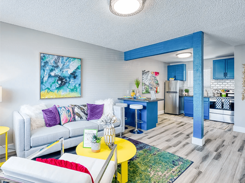 Fusion Las Vegas 1 bedroom apartments in Vegas living room with a white couch and a yellow coffee table.